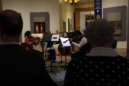 A string ensemble from the St. Louis Symphony Orchestra performs a public concert in the Old Courthouse.