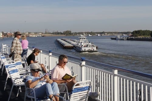 Queen of the Mississippi and other passenger vessels share the river with a variety of commercial barges.