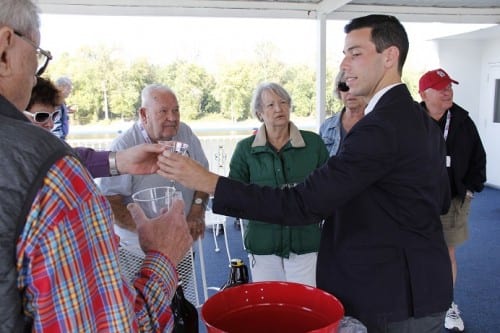 ACL Cruise Director Robert Alexander dispenses sample servings of craft beer from Mark Twain Brewing Co., onboard Queen of the Mississippi.